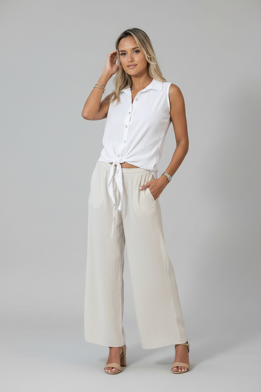 Thai beige pants by Cotton Natural featuring a relaxed fit, with visible waistband and lightweight fabric.