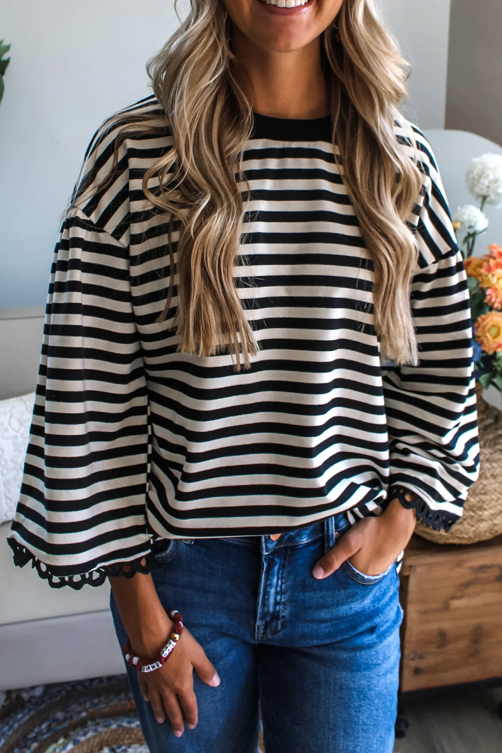 Black striped bell sleeve top by CSB Private Label, featuring flowy bell sleeves and a stylish striped pattern.