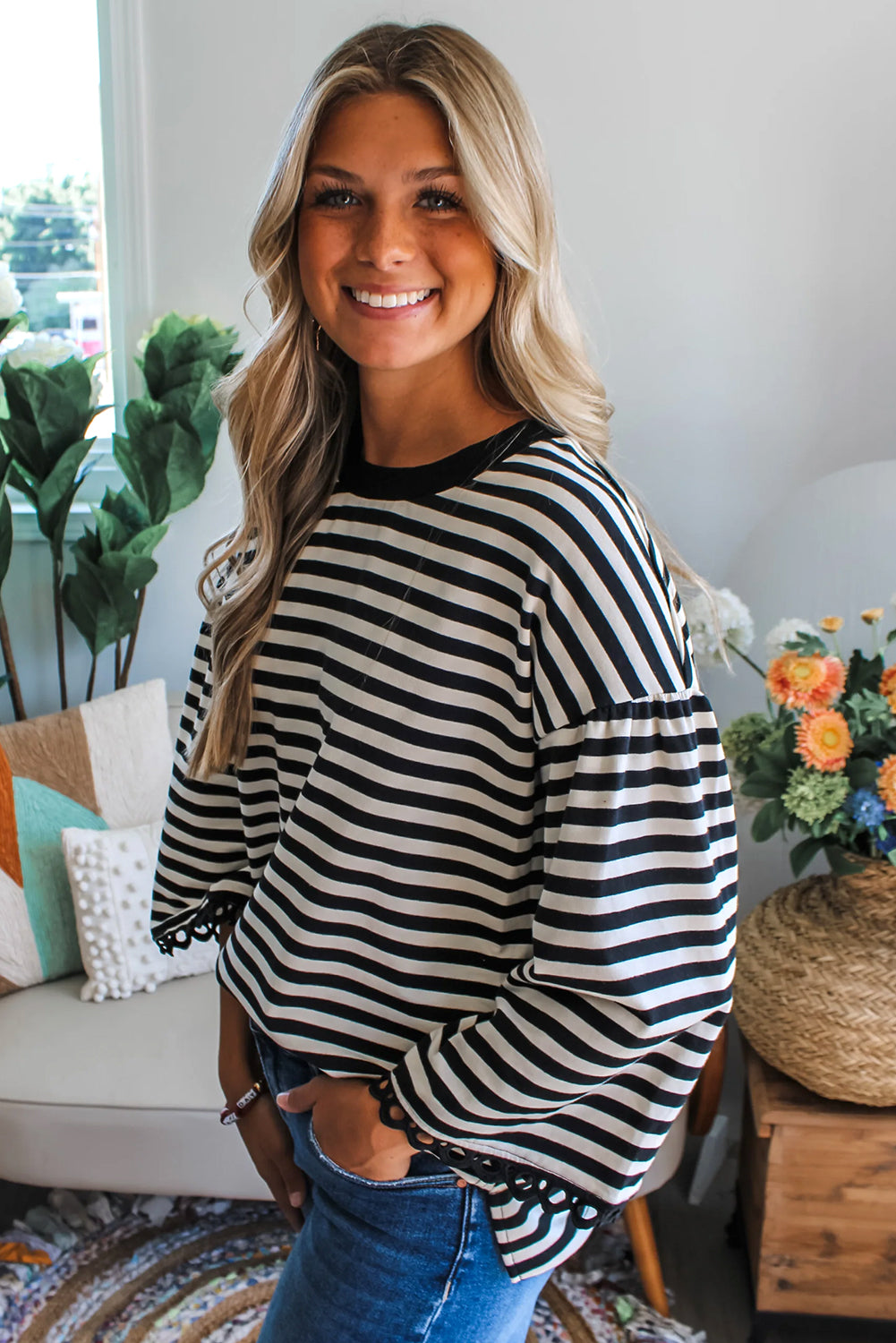 Black striped bell sleeve top by CSB Private Label, featuring a stylish design with bell sleeves and a fitted silhouette.