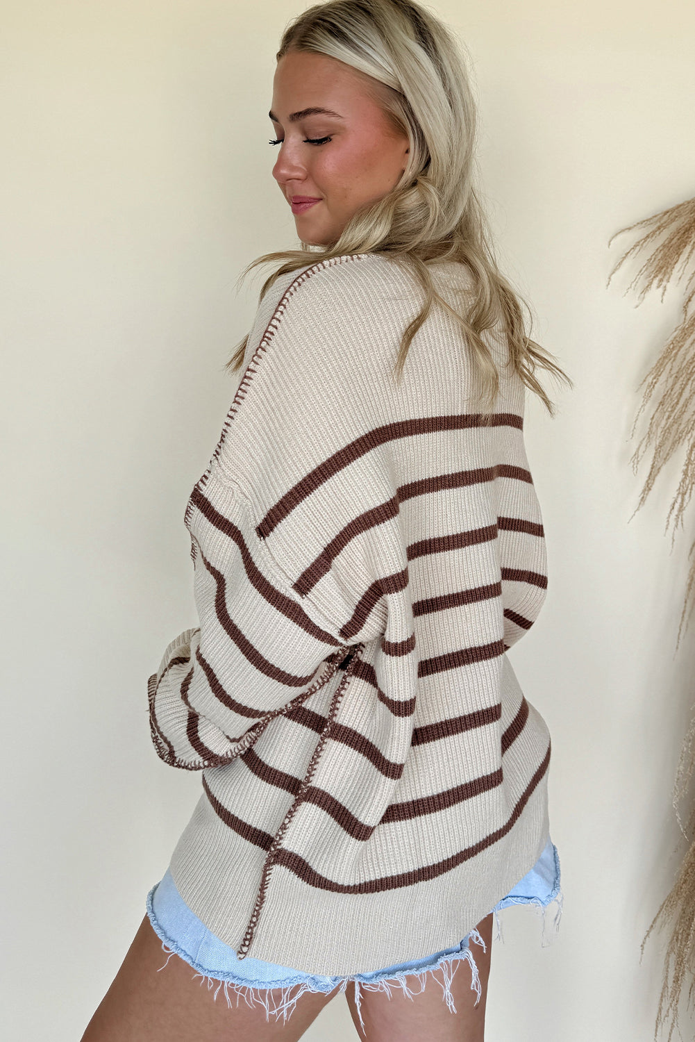 Brown striped Henley sweater by CSB Private Label, featuring a classic crew neckline and long sleeves on a model.