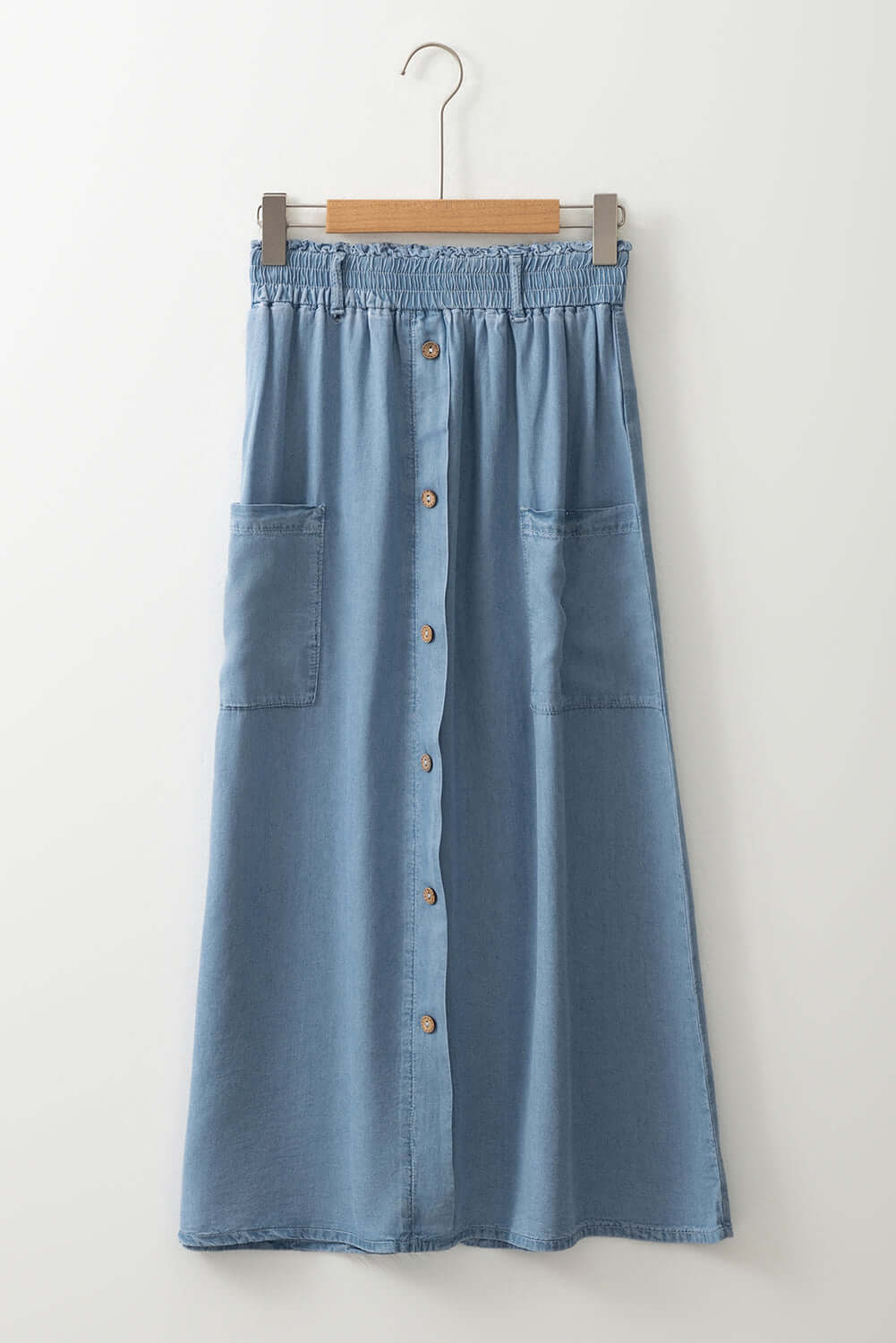 High waisted Beau blue skirt from CSB Private Label displayed on a hanger, showing its fabric and fit details.