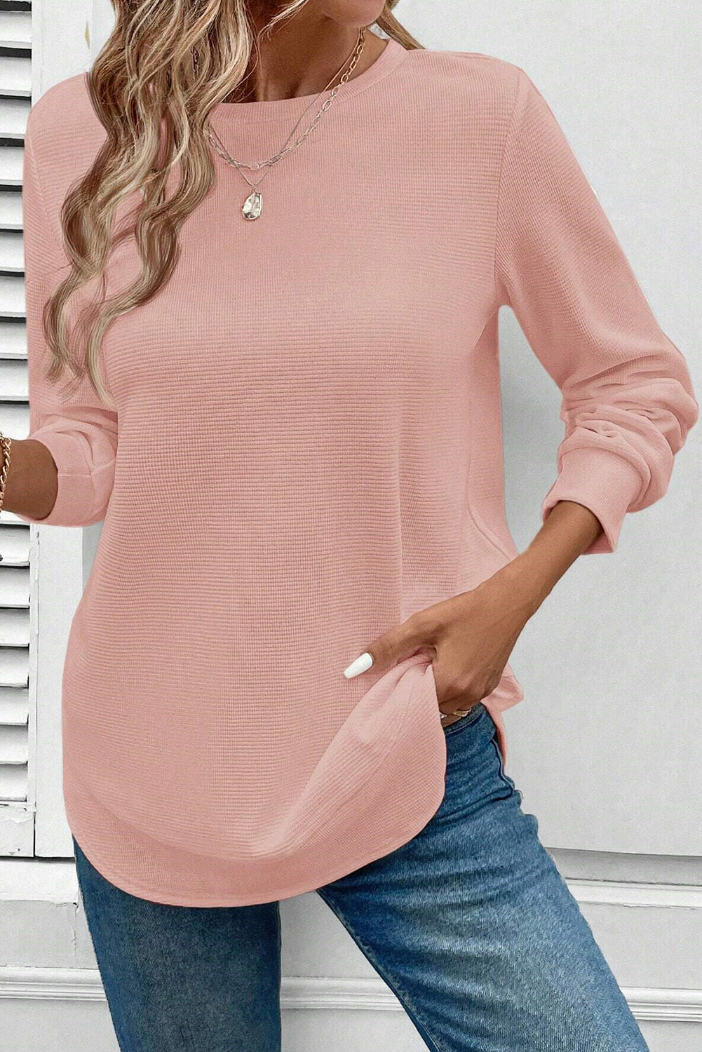 Pink rounded hem waffle long sleeve top by CSB Private Label, showing textured fabric and relaxed fit.