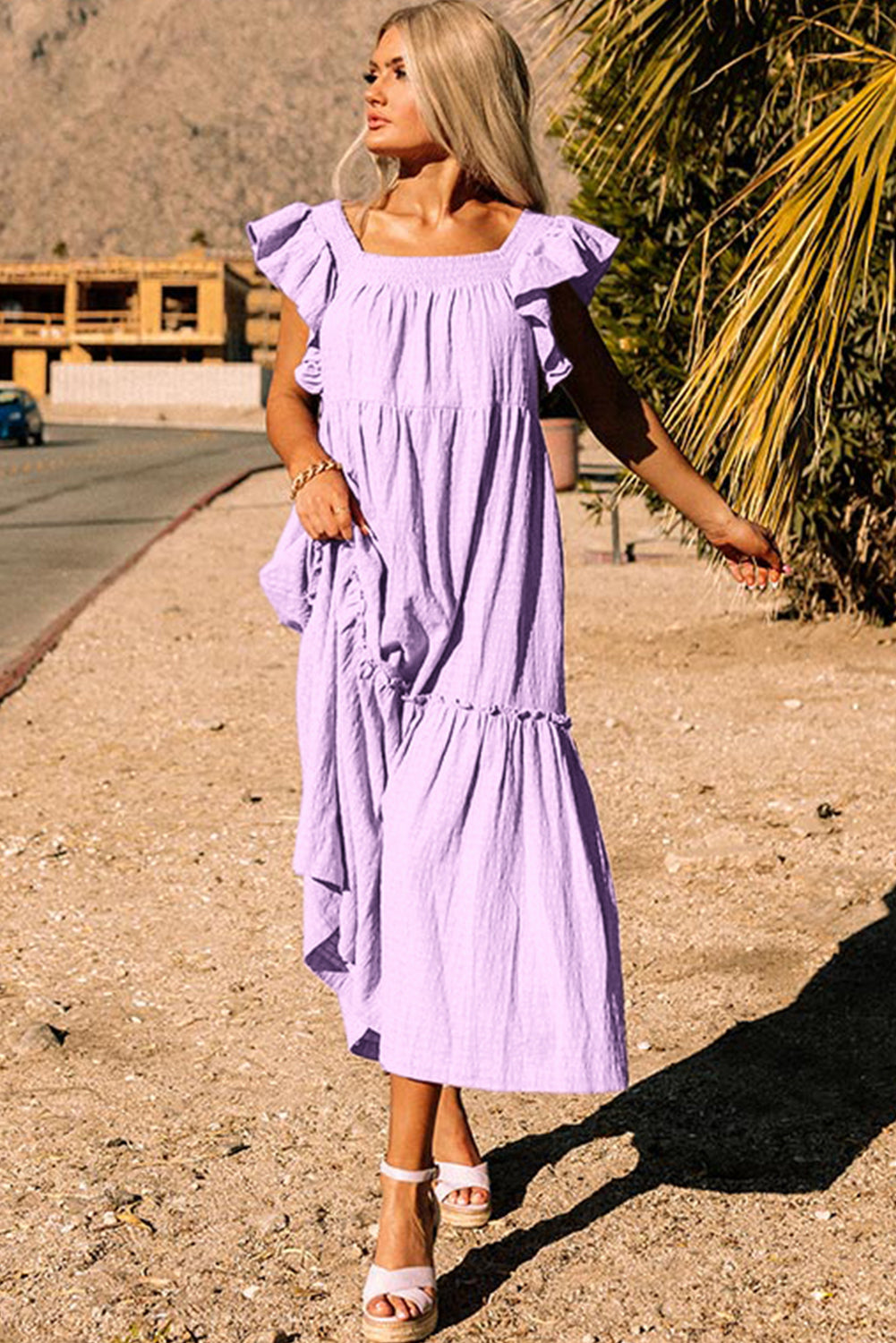 Purple ruffles maxi dress by CSB Private Label featuring flutter sleeves, square neckline, textured fabric, and tiered design.