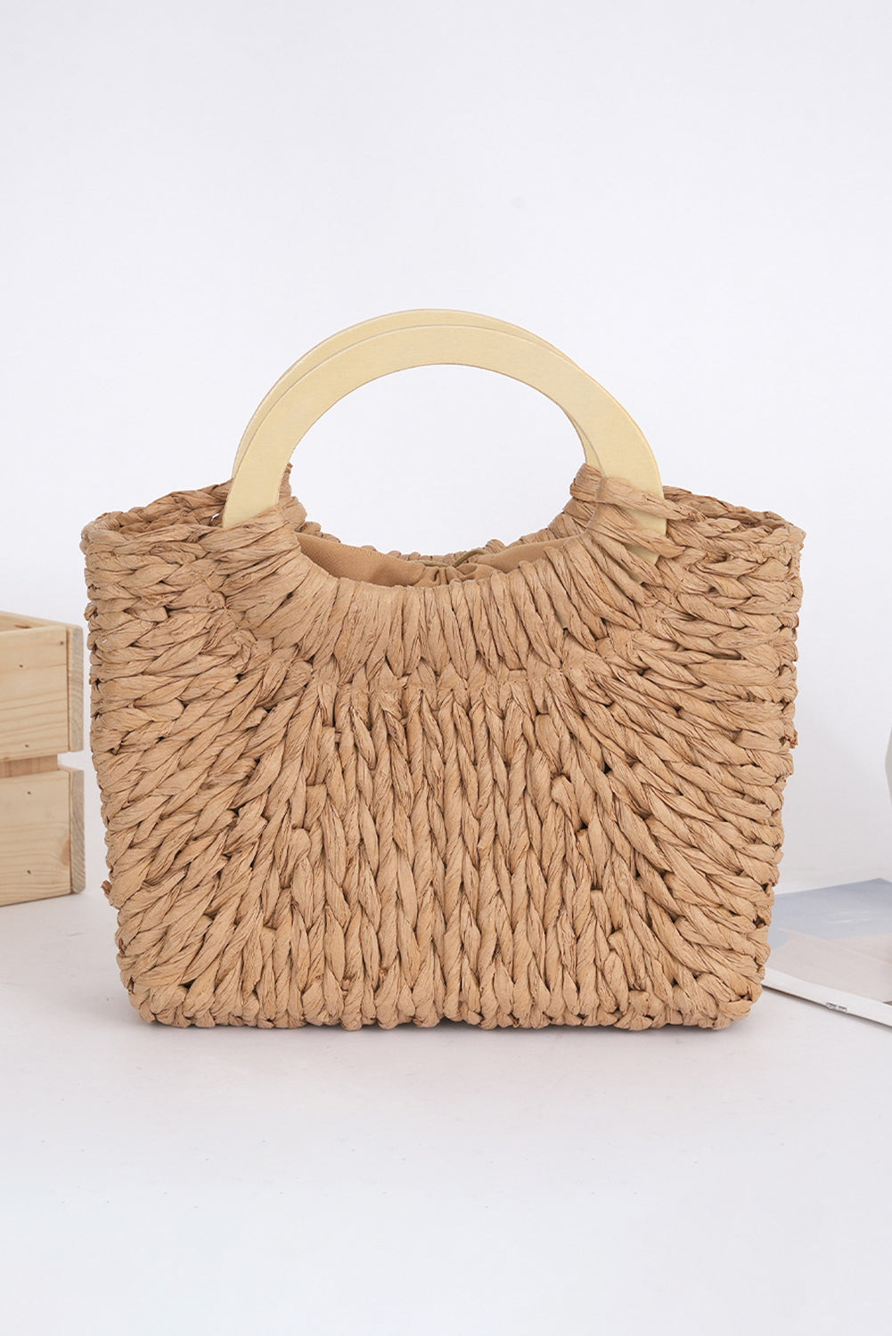 Camel woven straw tote bag with shoulder straps and woven texture, stylish and spacious for casual outings.