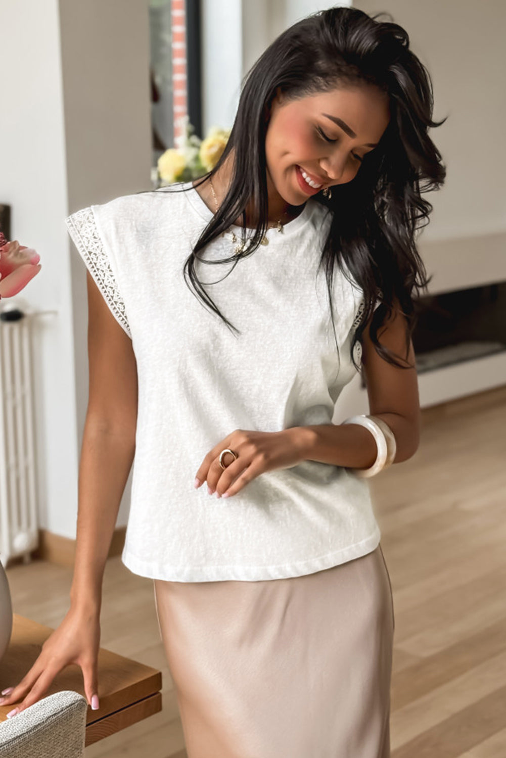White sleeveless T-shirt with lace trim from CSB Private Label, showing a close-up of the fabric and decorative lace details.
