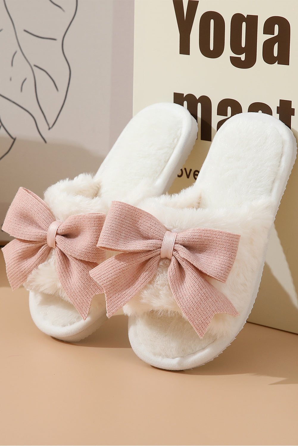 Pink Bow fuzzy slippers by CSB Private Label featuring soft plush material and a decorative bow on the front.