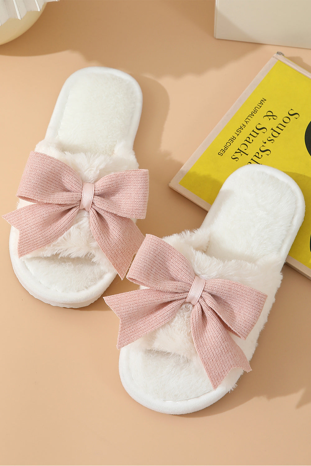 Pink Bow fuzzy slippers from CSB Private Label with soft plush material and decorative bow detail on the top.