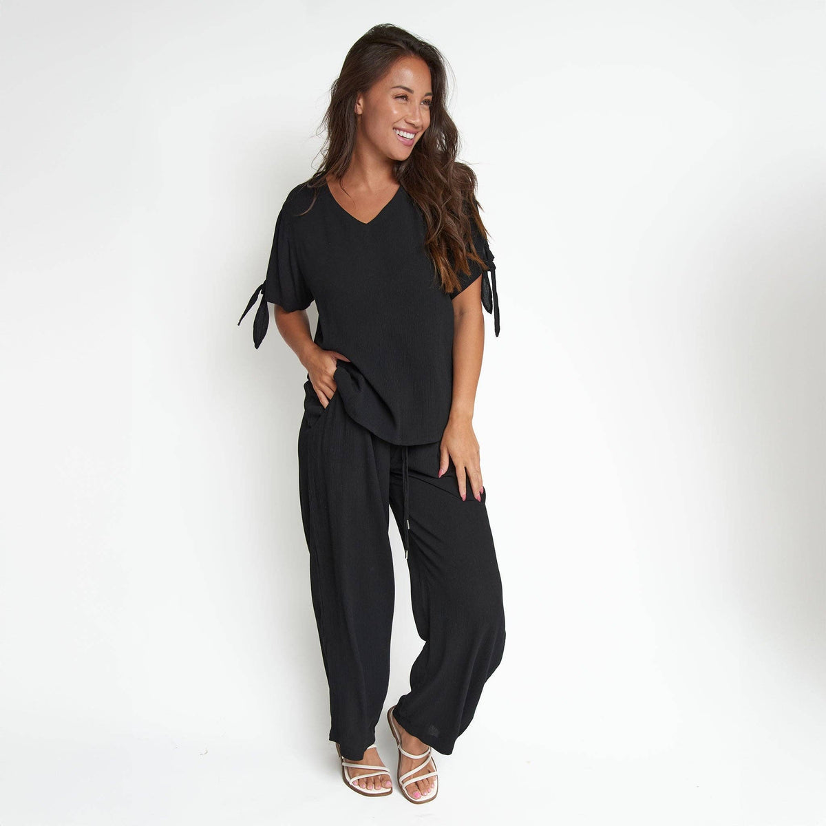 Elsie & Zoey Nika Crepe tied short sleeve V-neck blouse, lightweight and stylish, shown in a close-up image.