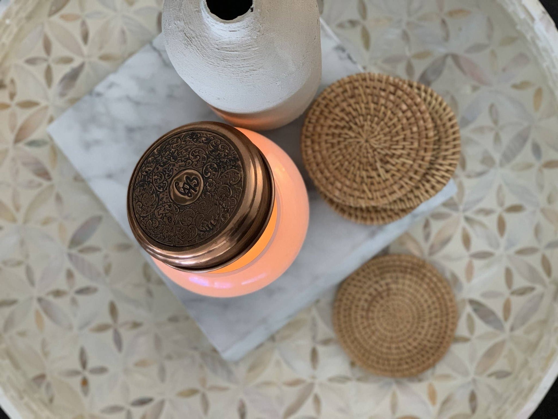 Set of natural rattan coasters by Delmar Decor, showcasing woven circular design for protecting surfaces and adding rustic charm.