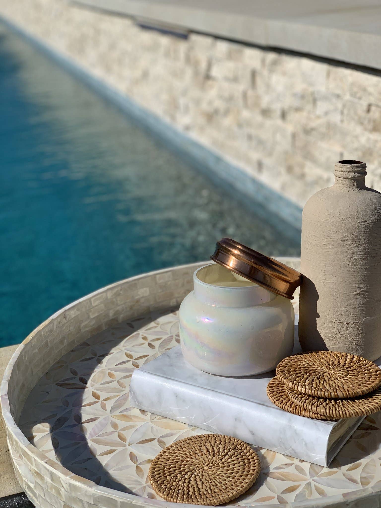 Set of natural rattan coasters from Delmar Decor, showcasing round woven design for protecting surfaces.
