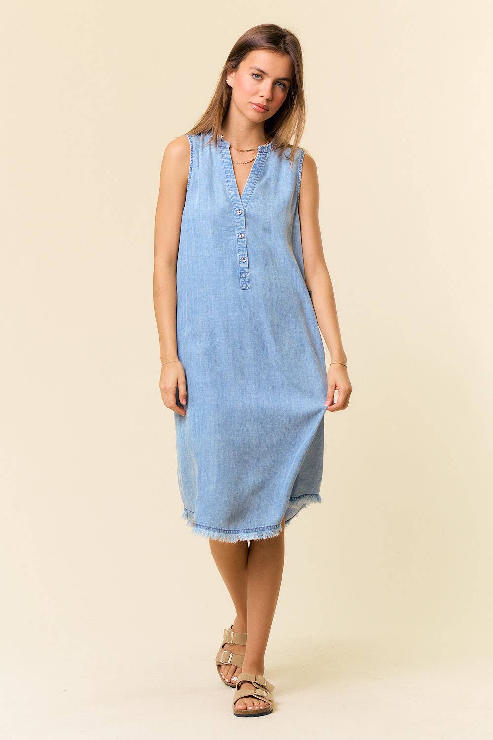 Tencel denim knee-length sleeveless Henley dress by Doe and Rae, showing a casual sleeveless dress with a Henley neckline and denim fabric.