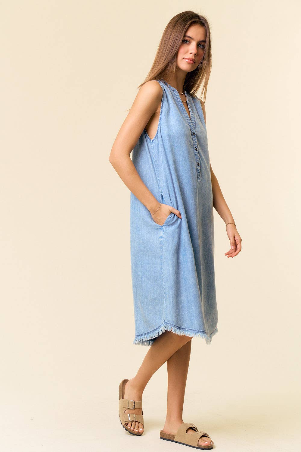 Tencel denim sleeveless knee-length Henley dress by Doe and Rae featuring a button-up front and casual fit.