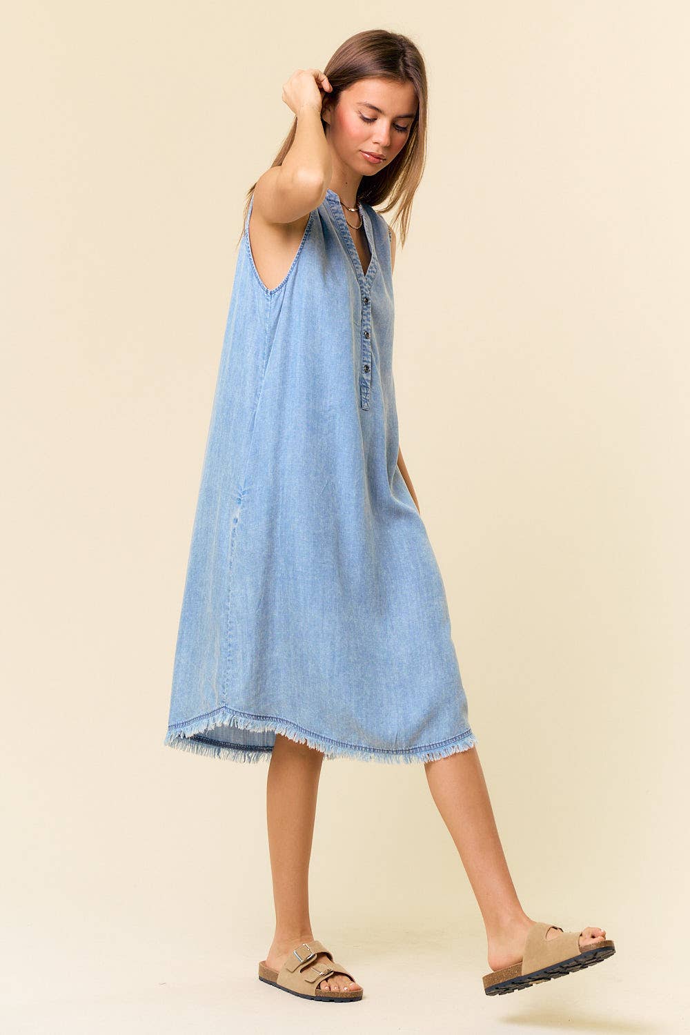 Doe and Rae Tencel denim knee-length sleeveless Henley dress with button front and casual fit, styled for warm weather.