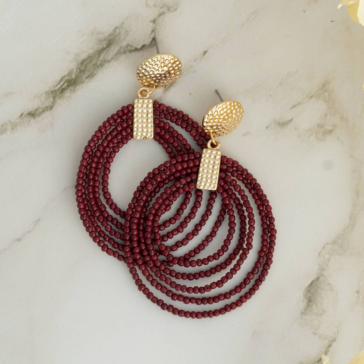 Nickel-free Howard's hoop seed bead drop earrings featuring colorful seed beads and a sleek hoop design.