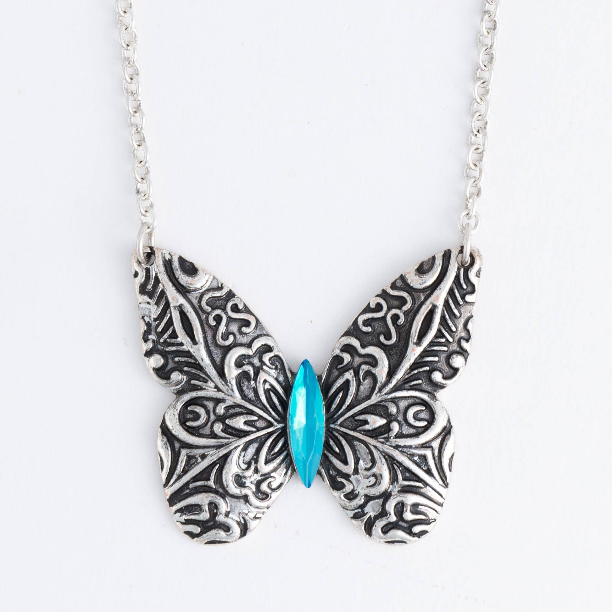 Antique silver butterfly pendant necklace with engraved details on an 18-inch chain, featuring a delicate Howard's design.