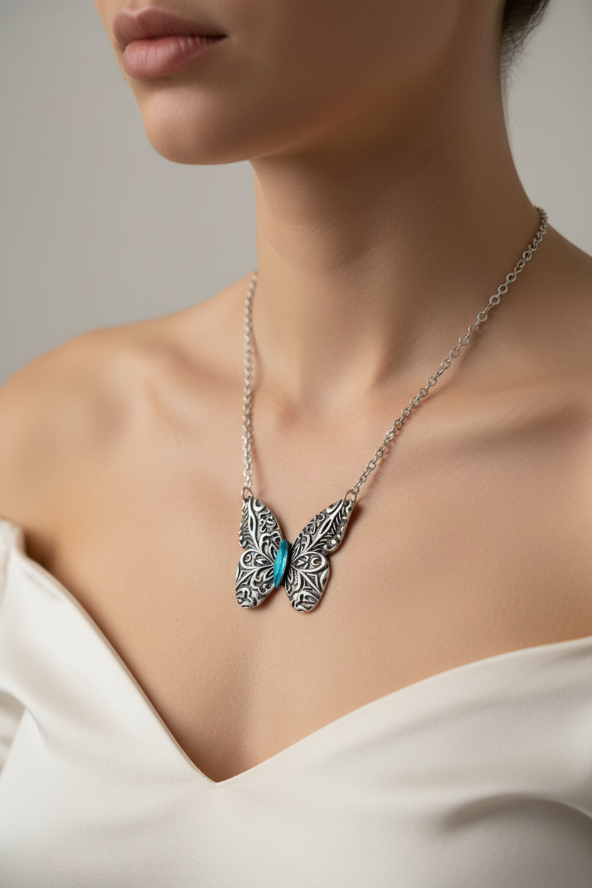 Antique silver butterfly pendant necklace with engraved details on an 18-inch chain, showcasing intricate craftsmanship.