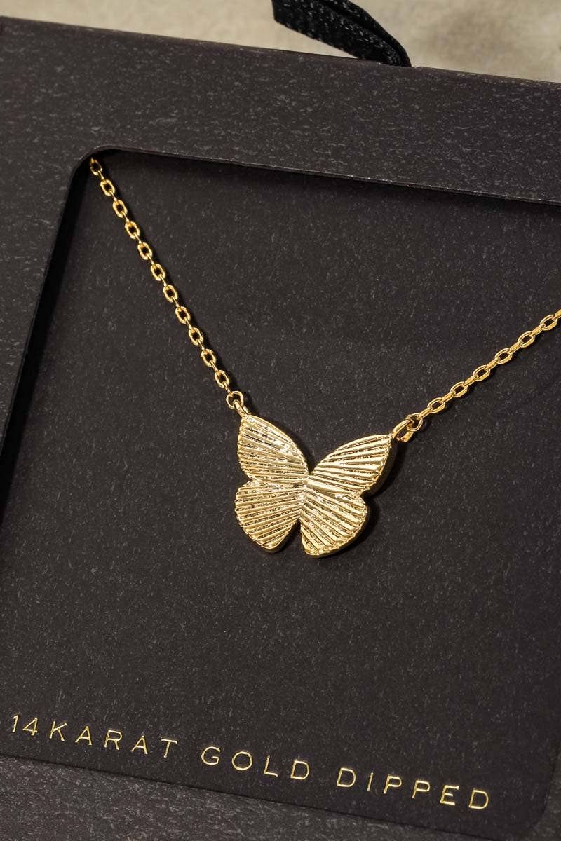 Gold butterfly necklace on a black card with '14Karat Gold Dipped' text