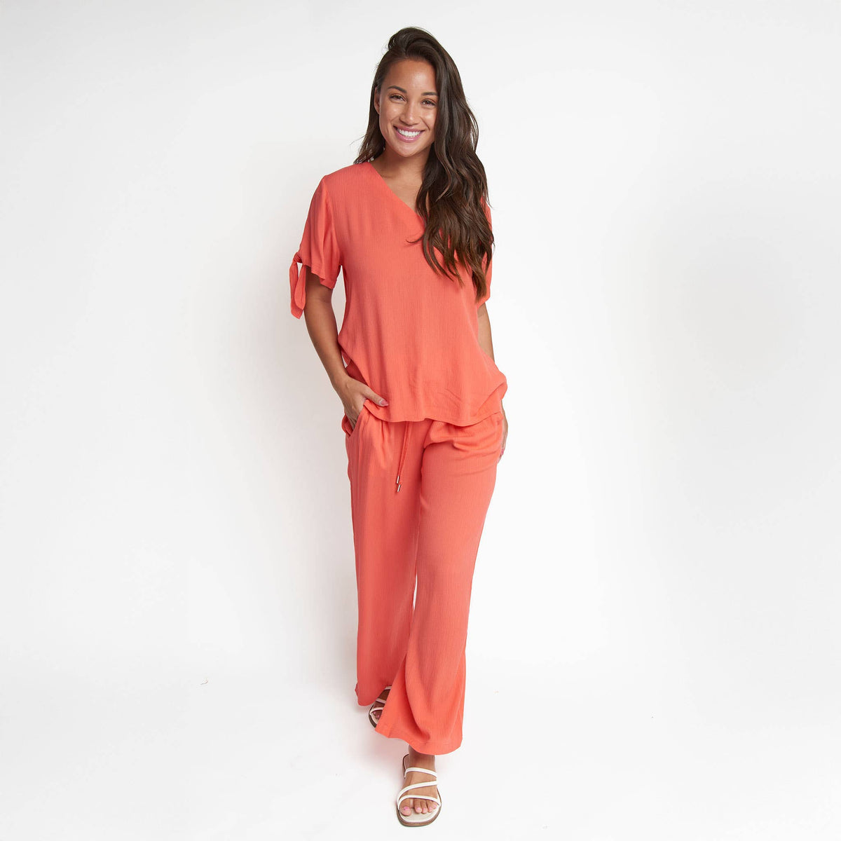 Elsie & Zoey Nika Crepe tied short sleeve V-neck blouse, shown in soft fabric with a relaxed fit and tied front design.