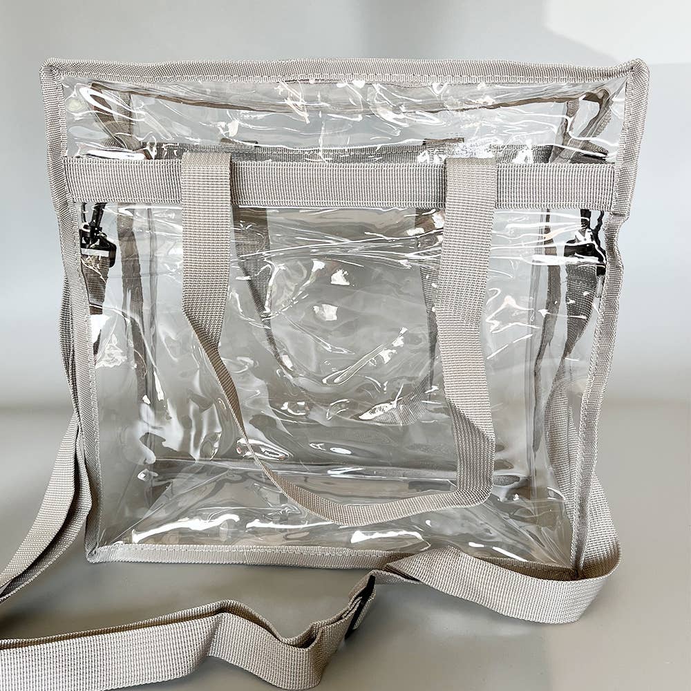 Clear tote bag with handles and zipper closure, stadium approved, by Wholesalesir, showing its see-through design and secure closure.
