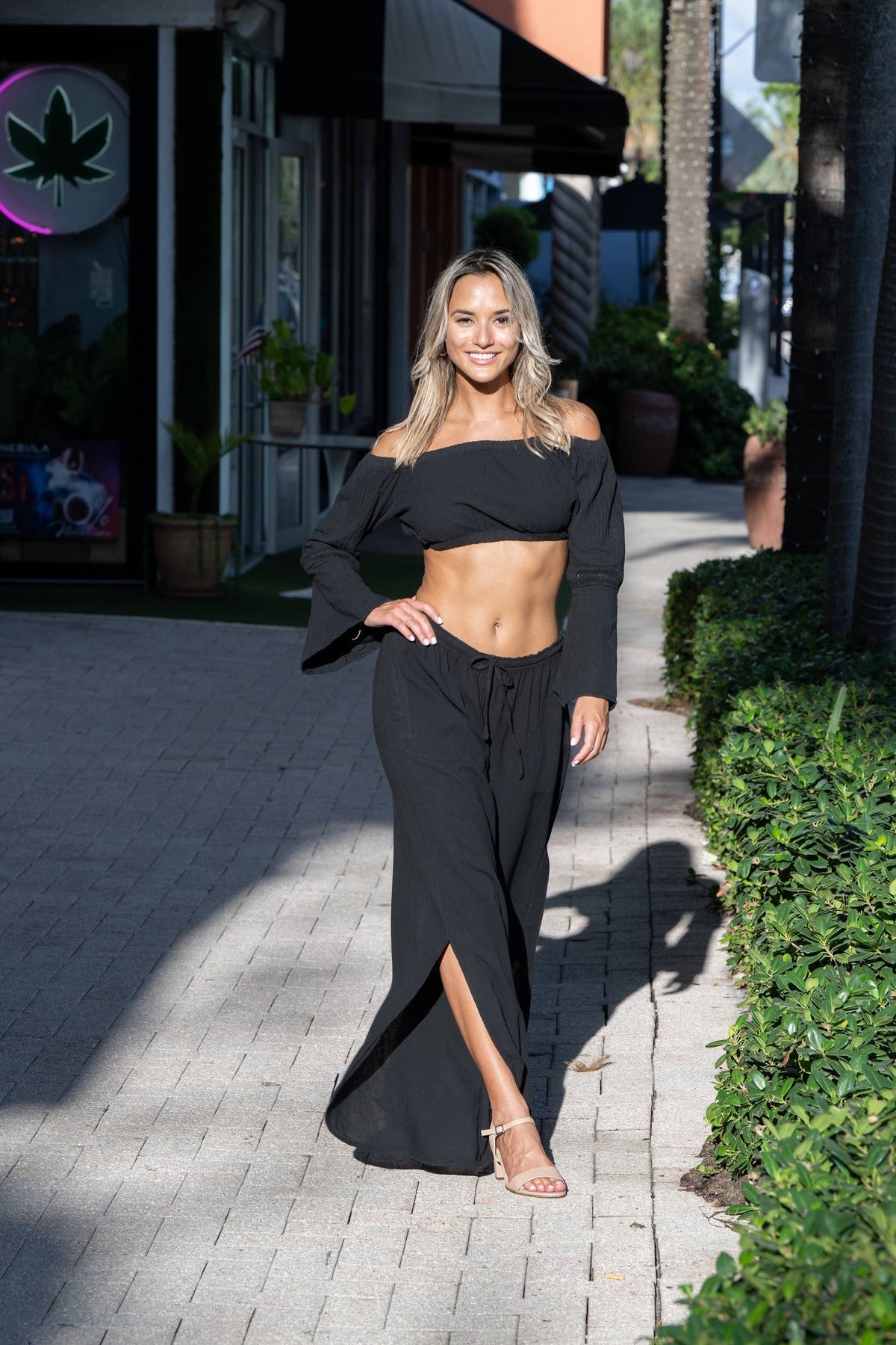 Thai Black Pants by Cotton Natural, featuring a relaxed fit and lightweight fabric, shown in a stylish outdoor setting.