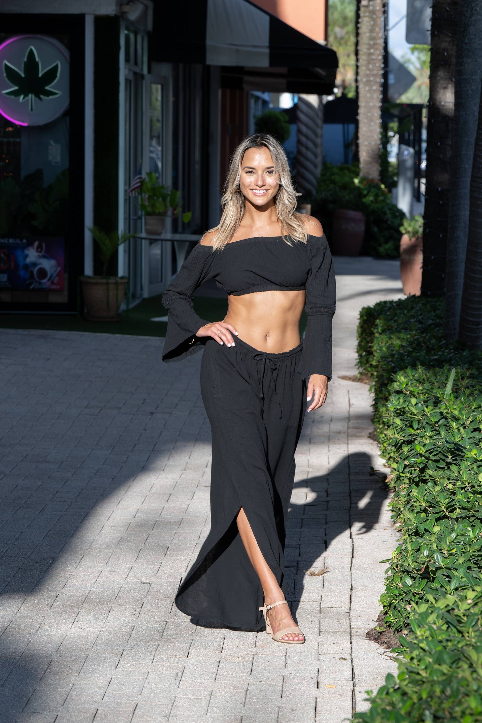 Thai Black Pants by Cotton Natural, featuring a relaxed fit and lightweight fabric, shown in a stylish outdoor setting.