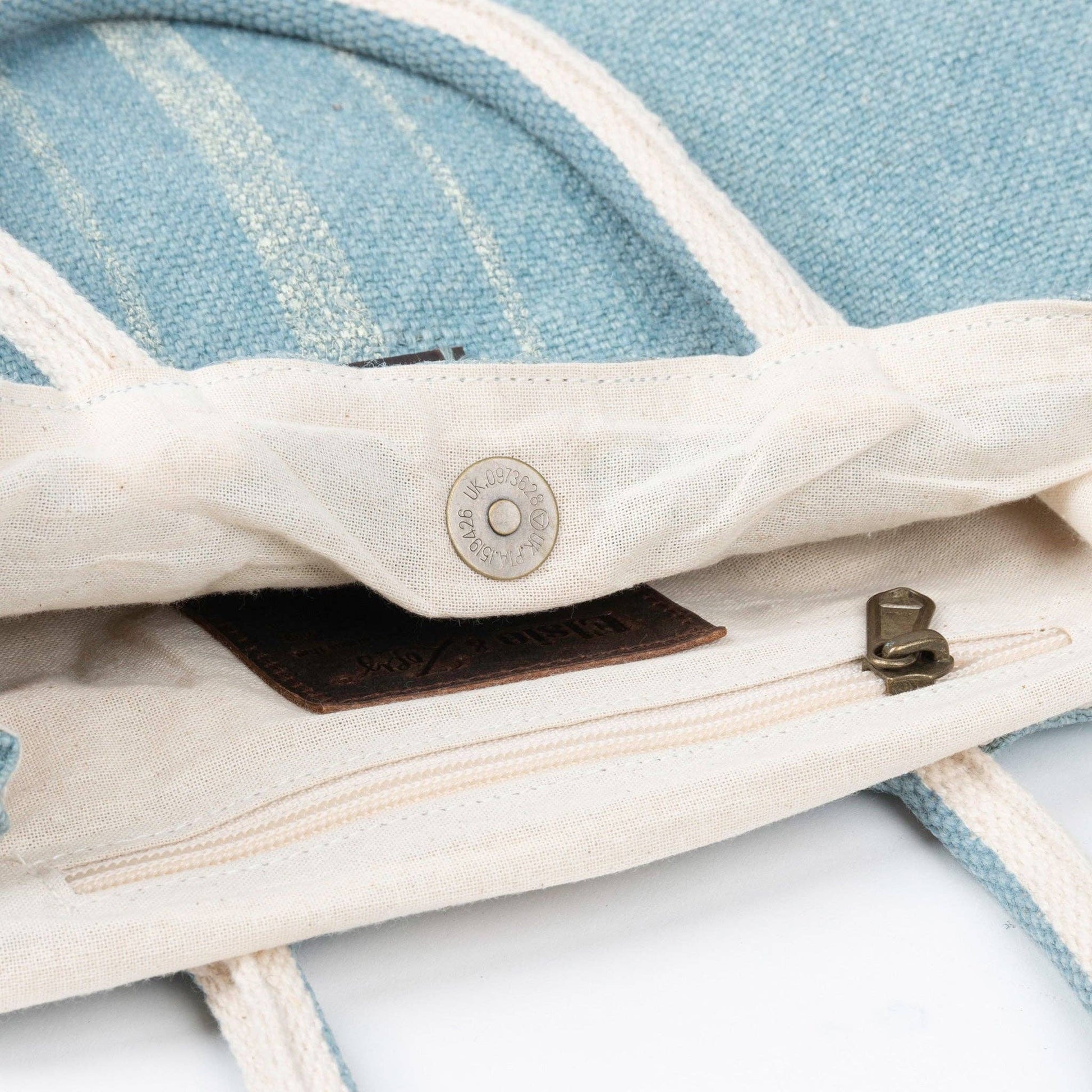 Howard's Inara jute handled tote bag with snap closure, showing its natural woven texture and spacious interior.