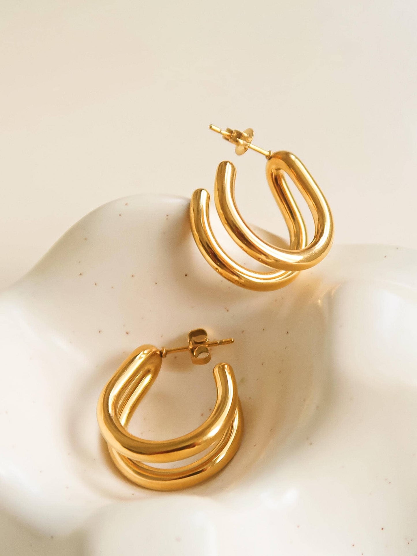 18K gold non-tarnish double C hoop earring by Flanerie by MAIQ, featuring a shiny gold finish and double hoop design.