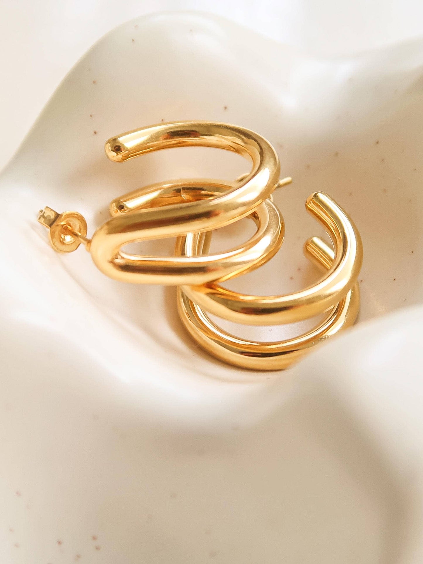 18K gold double C hoop earring by Flanerie by MAIQ, non-tarnish, shiny gold finish, close-up of stylish hoop jewelry.