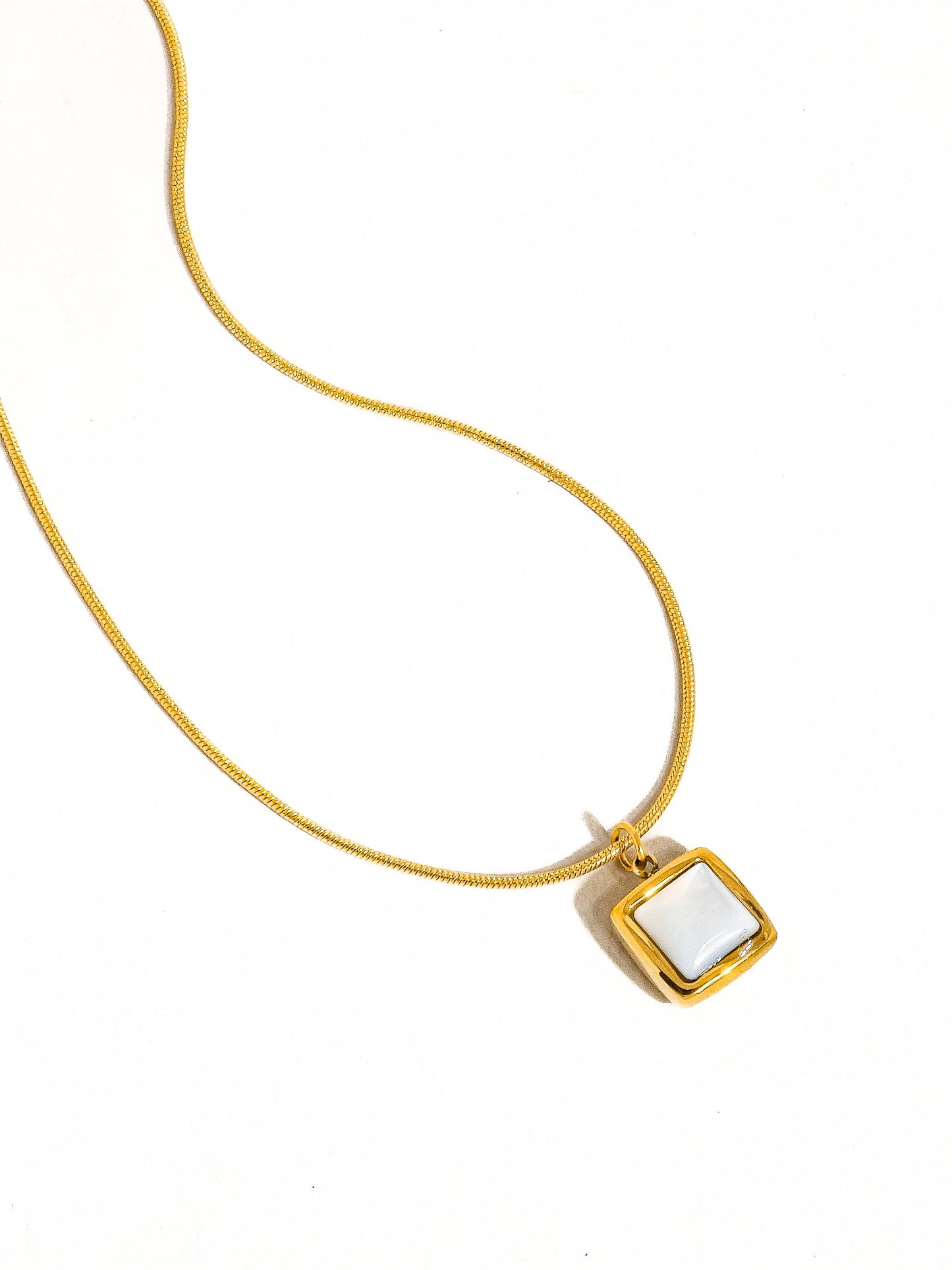 18K gold non-tarnish square shell necklace by Flanerie by MAIQ, featuring a sleek square shell pendant on a delicate chain.
