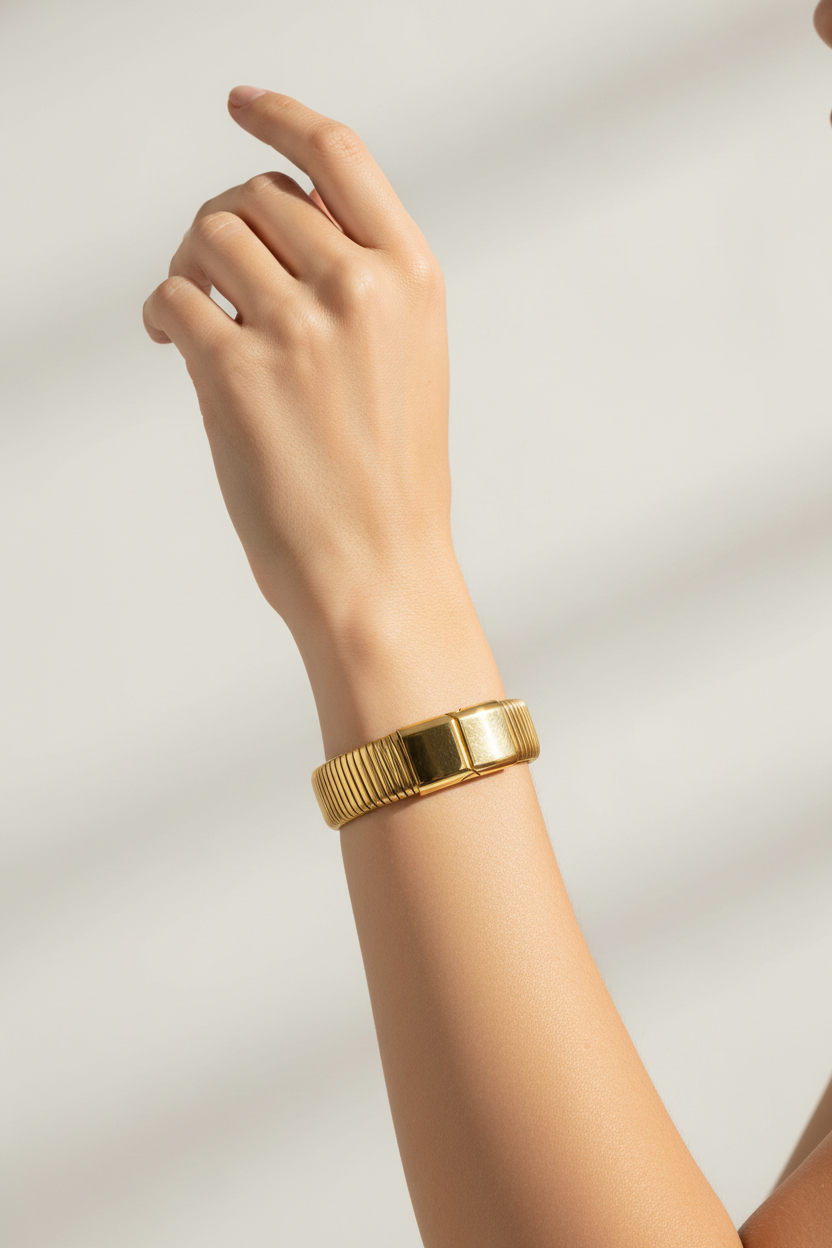 Christel 18K gold non-tarnish stripe bold bangle by Flanerie by MAIQ, featuring a sleek gold design with stripe accents.