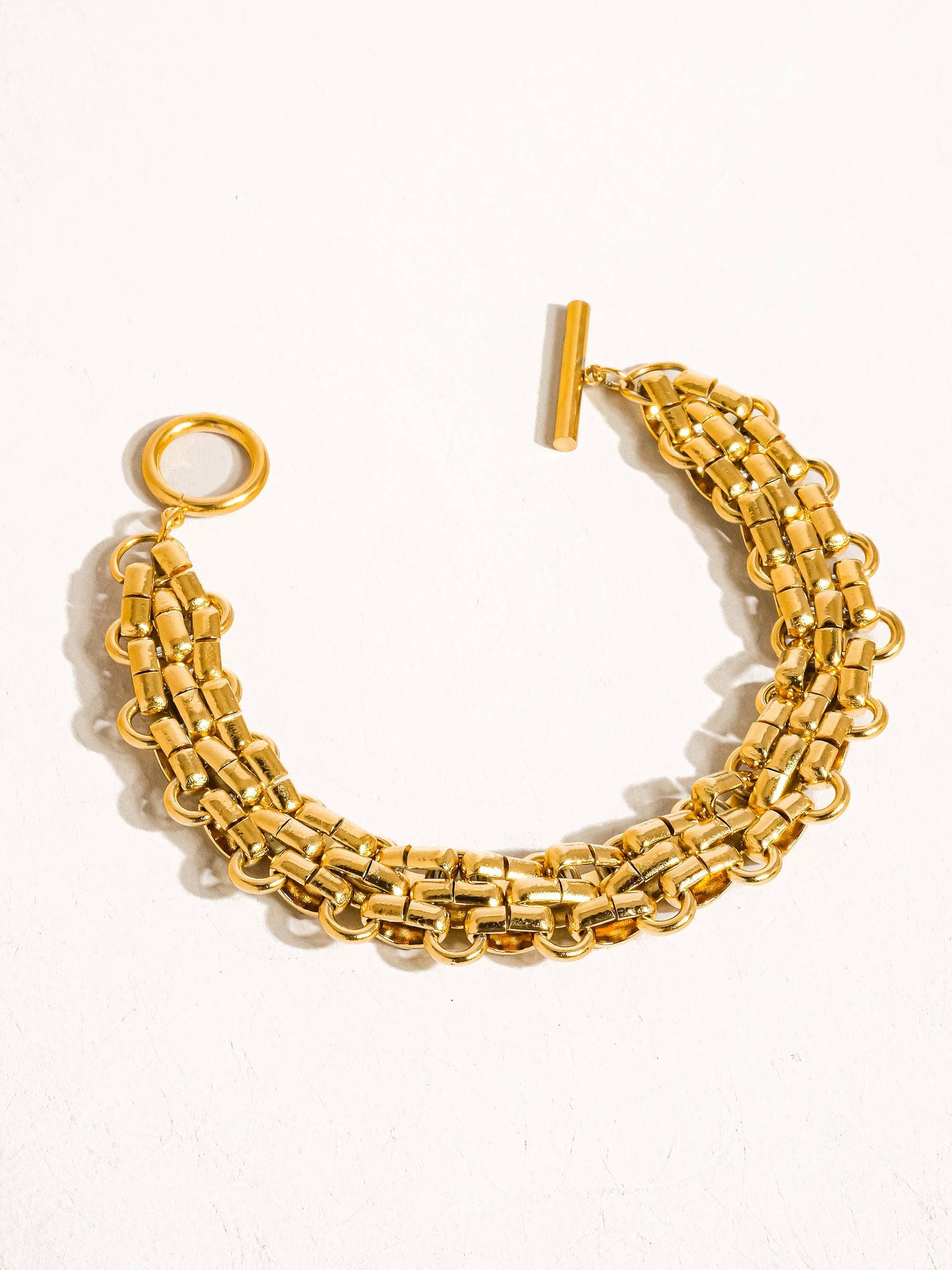 Donni 18K gold non-tarnish bold weave bracelet by Flanerie by MAIQ, featuring a textured gold woven design.