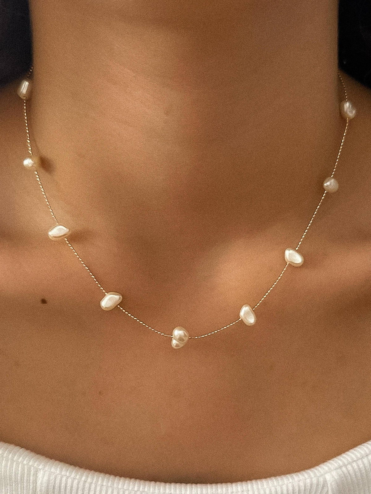 Ida 18K non-tarnish petite pearl necklace by Flanerie by MAIQ, featuring a delicate string of small lustrous pearls.