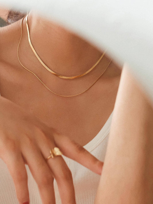 18K gold layered flat snake chain necklace by Flanerie by MAIQ, showcasing a sleek, non-tarnish gold jewelry design