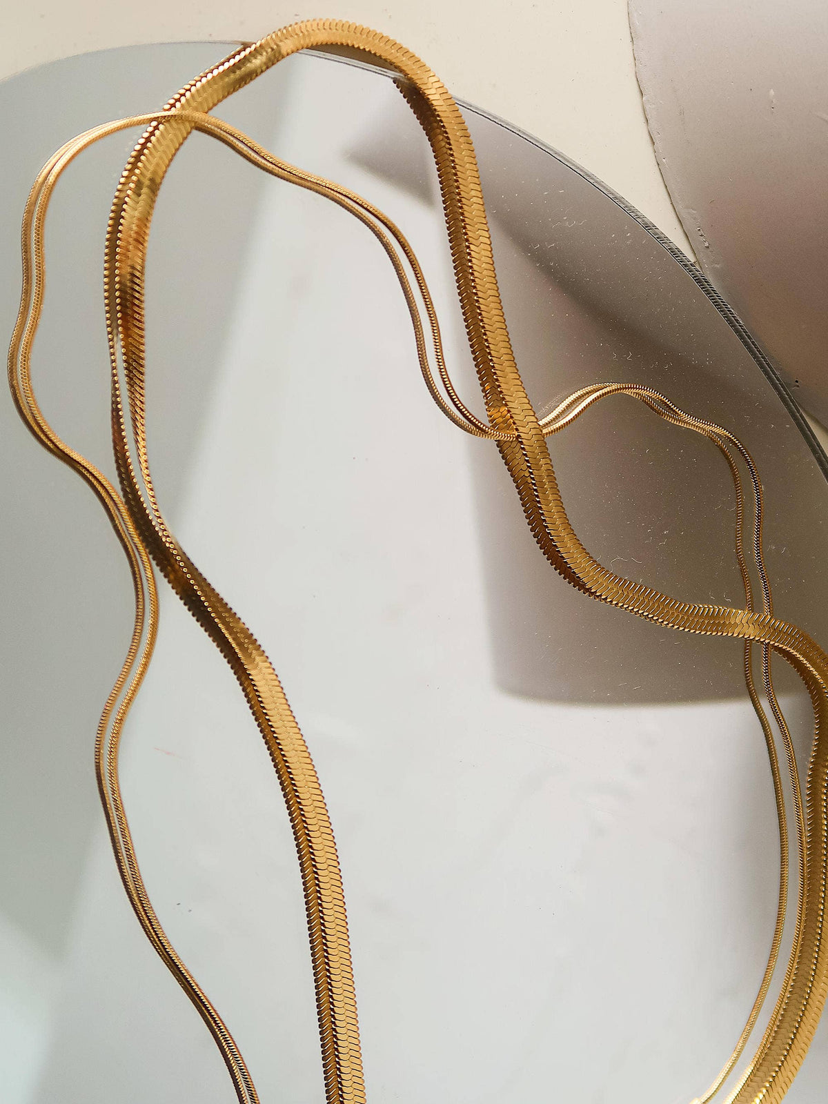 18K gold layered flat snake chain necklace by Flanerie by MAIQ, featuring a non-tarnish gold finish and intricate snake chain design.