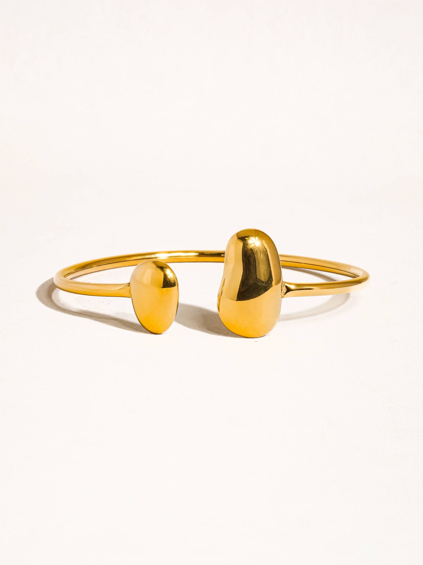 Mazie 18K non-tarnish round thin bracelet by Flanerie by MAIQ, showcasing a delicate gold bracelet with a smooth, polished finish.