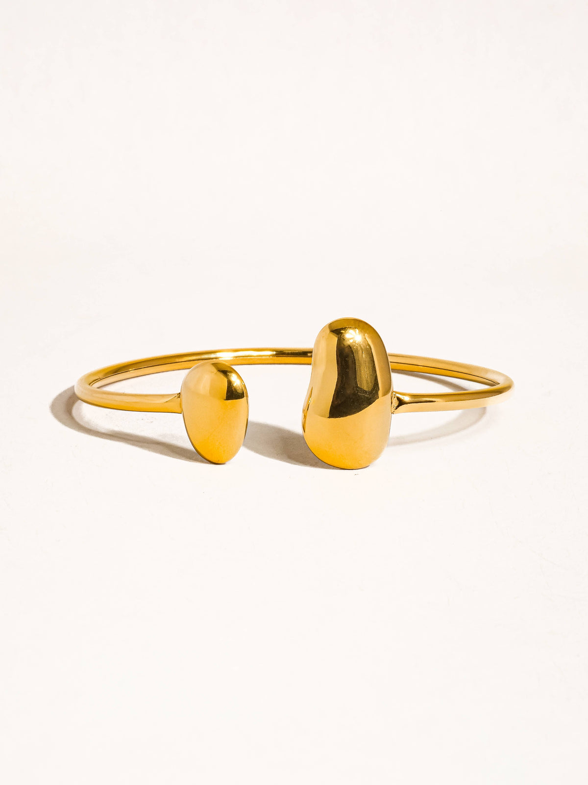 Mazie 18K non-tarnish round thin bracelet by Flanerie by MAIQ, showcasing a delicate gold bracelet with a smooth, polished finish.
