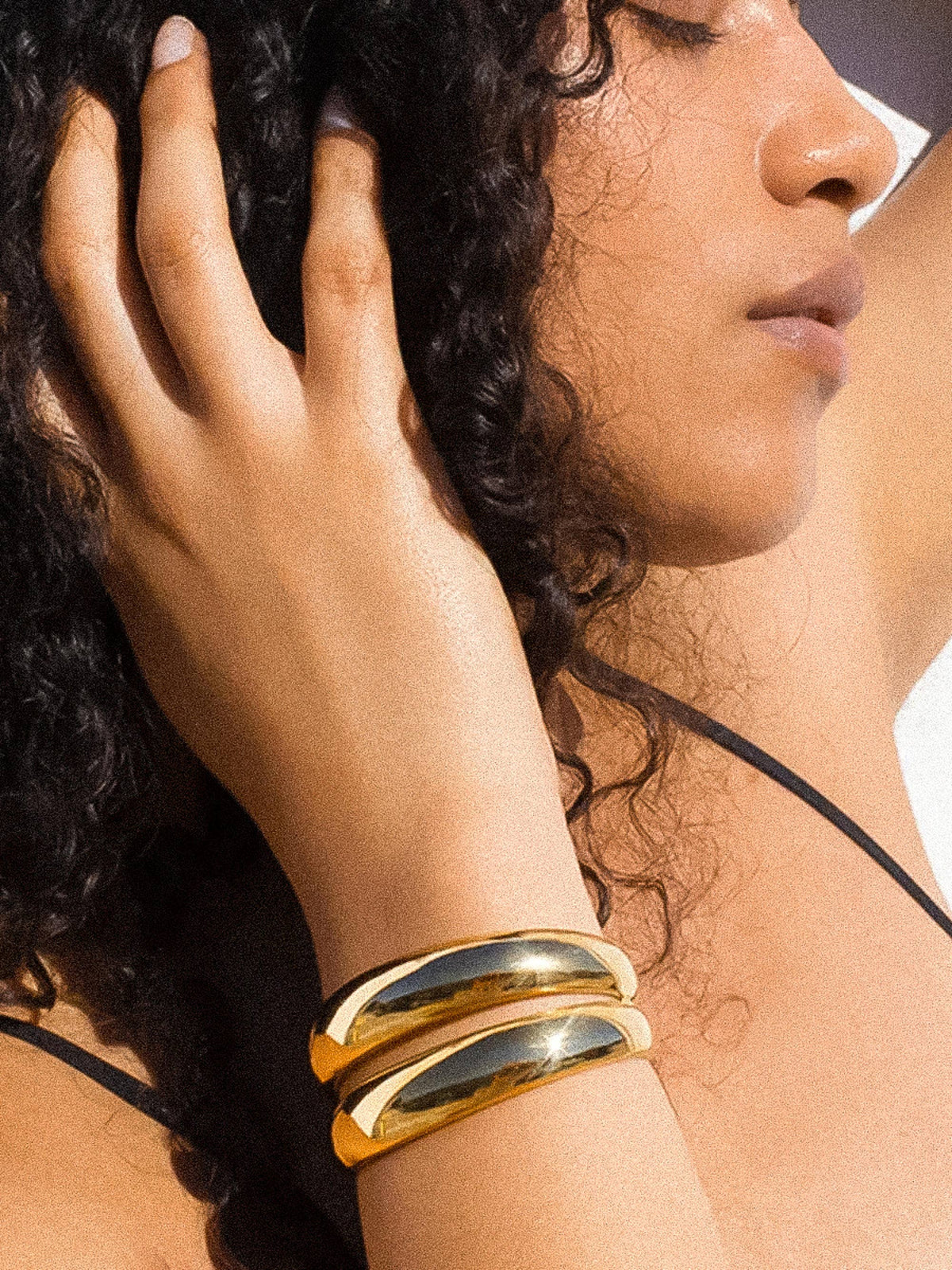 Ronan 18K gold layered round bangle by Flanerie by MAIQ, non-tarnish gold jewelry with a smooth, polished finish.