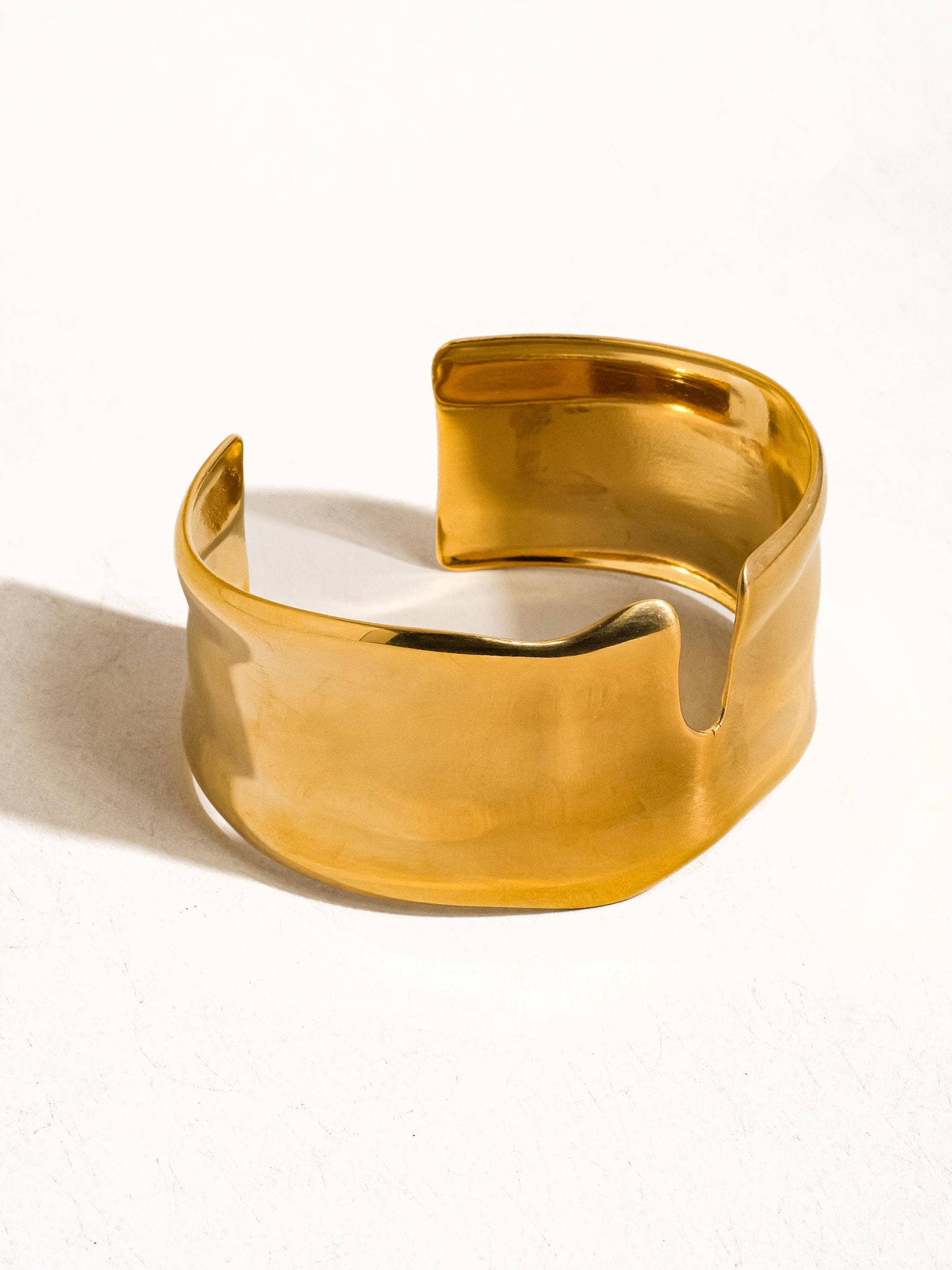 Water resistant 18K gold abstract bold bangle by Flanerie by MAIQ, showcasing a sleek, modern design with a polished finish.