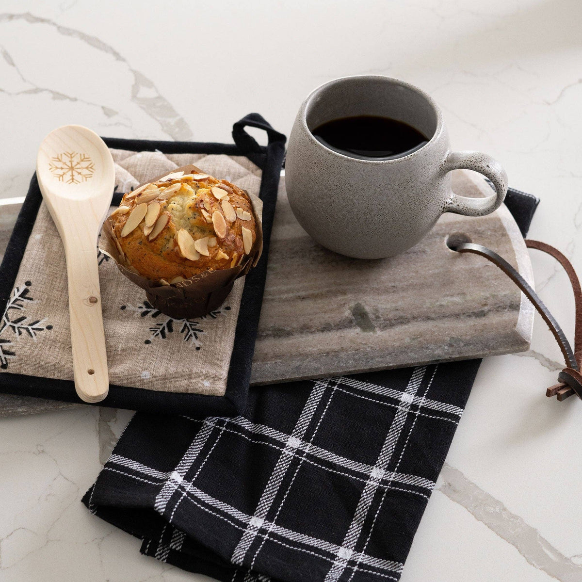 Howard's 3-piece neutral snowflake kitchen set featuring snowflake designs on dish towels and oven mitts for winter decor and functionality.
