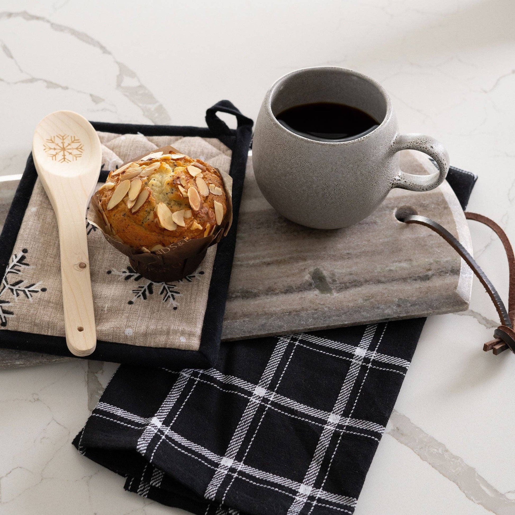 Howard's 3-piece neutral snowflake kitchen set featuring snowflake designs on dish towels and oven mitts for winter decor and functionality.