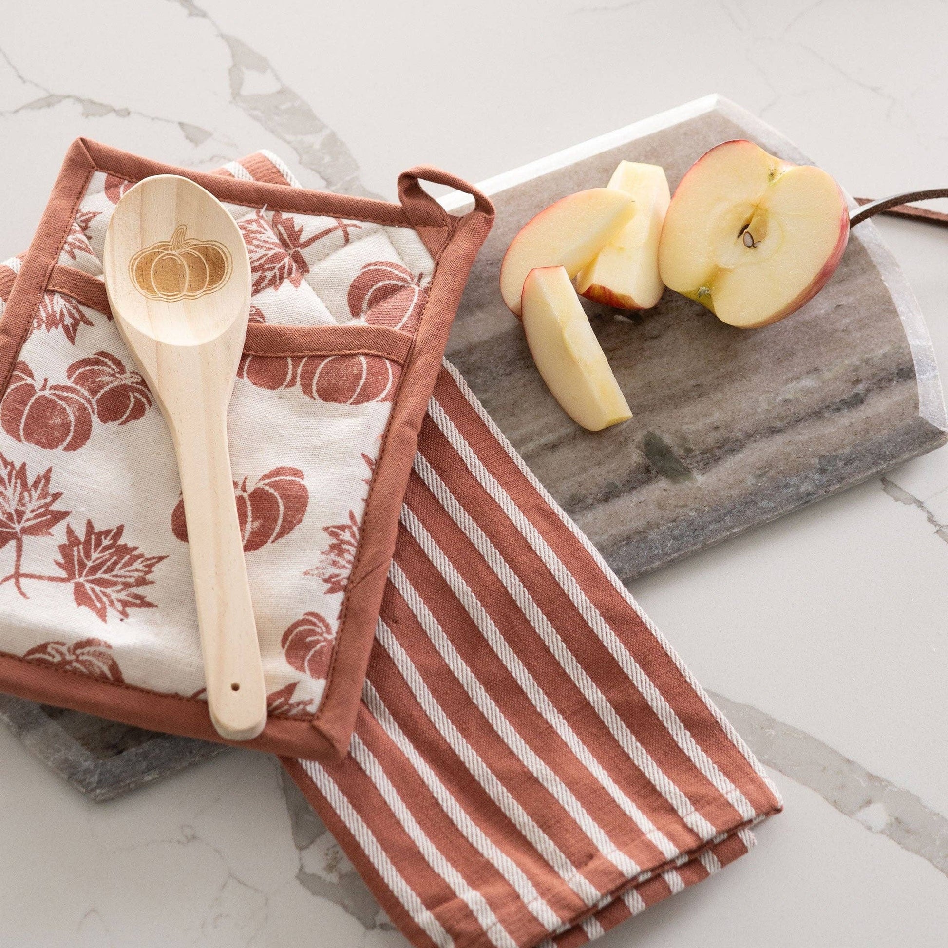 Howard's 3-piece pumpkin harvest kitchen set with ceramic pumpkin utensils on a wooden countertop.