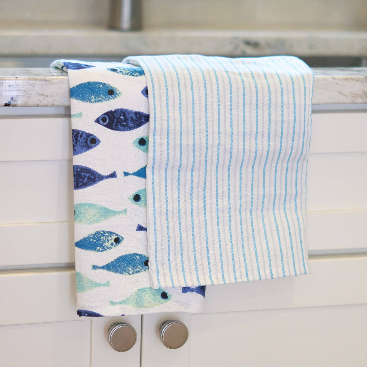 Three seafoam stripe tea towels from Howard's 3-piece set, featuring soft fabric and vibrant coastal-inspired stripe patterns.