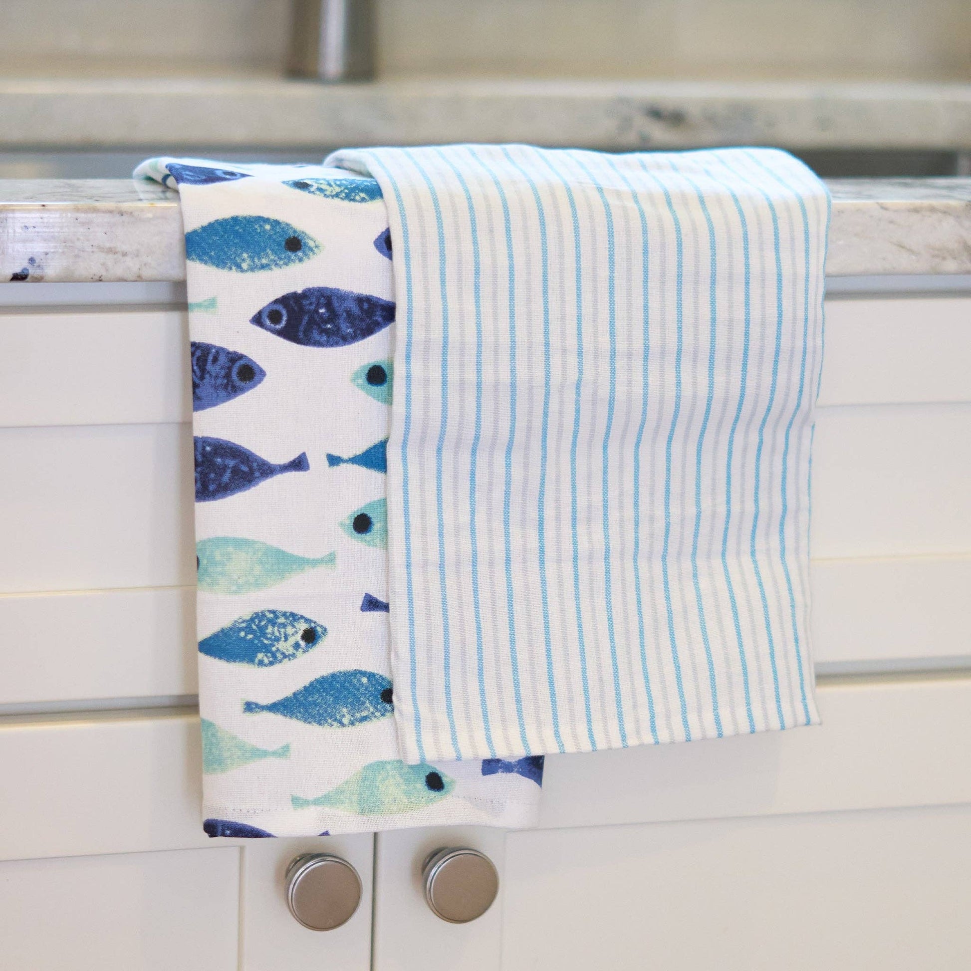 Three seafoam stripe tea towels from Howard's 3-piece set, featuring soft fabric and vibrant coastal-inspired stripe patterns.