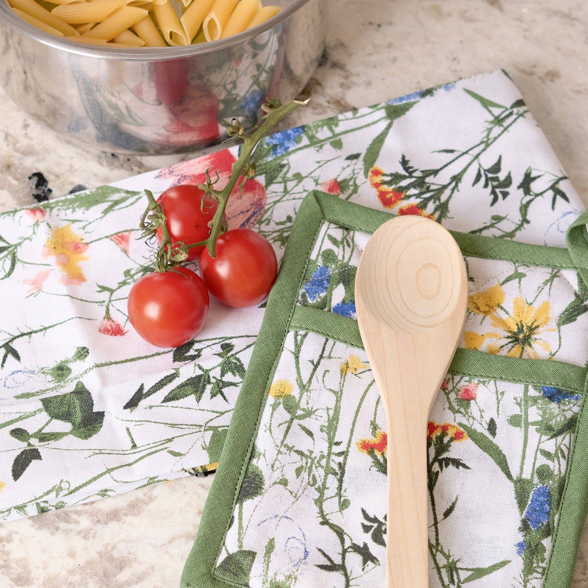 Howard's 3-piece Spring Meadow cotton kitchen set with floral-patterned dish towels and oven mitts on a countertop.