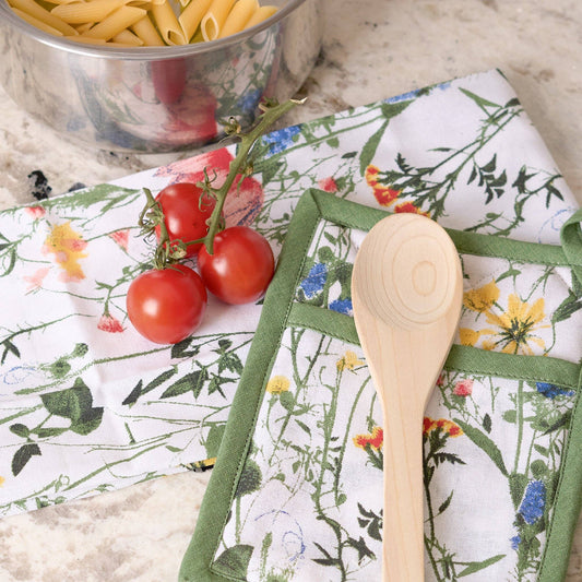 Howard's 3-piece Spring Meadow cotton kitchen set with floral-patterned dish towels and oven mitts on a countertop.