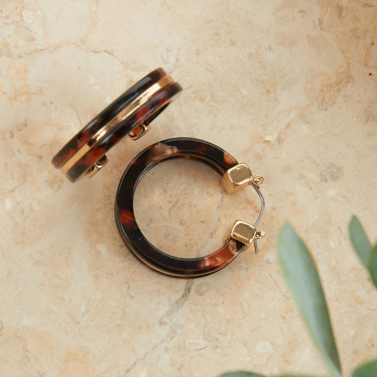 Howard's Sloane tortoiseshell circle acrylic hoop earring with a classic tortoise pattern, lightweight and stylish for everyday wear.