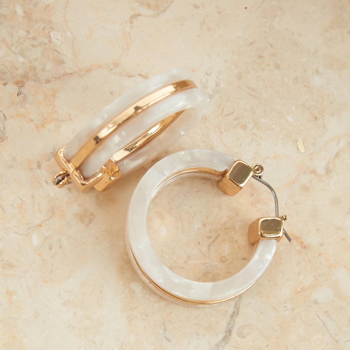 Howard's Sloane Tortoiseshell Circle Acrylic Hoop Earring featuring a classic tortoise shell design and gold-tone accents.