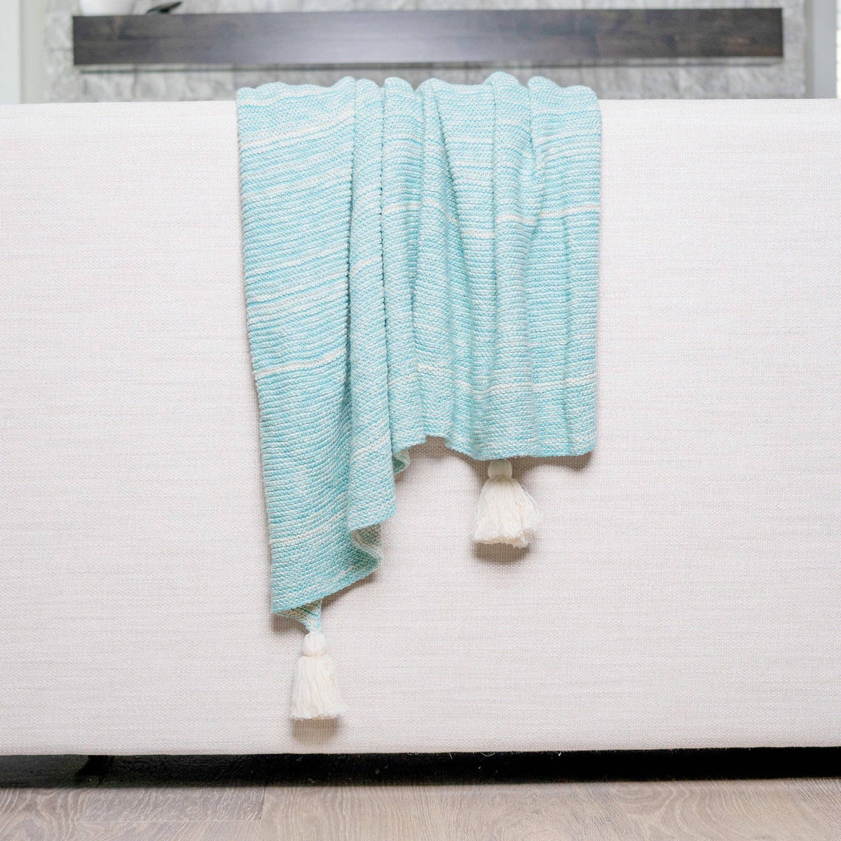 Teal cotton throw blanket by Howard's Necalli, 50x60 inches, marled knit decorative blanket on a cozy sofa.