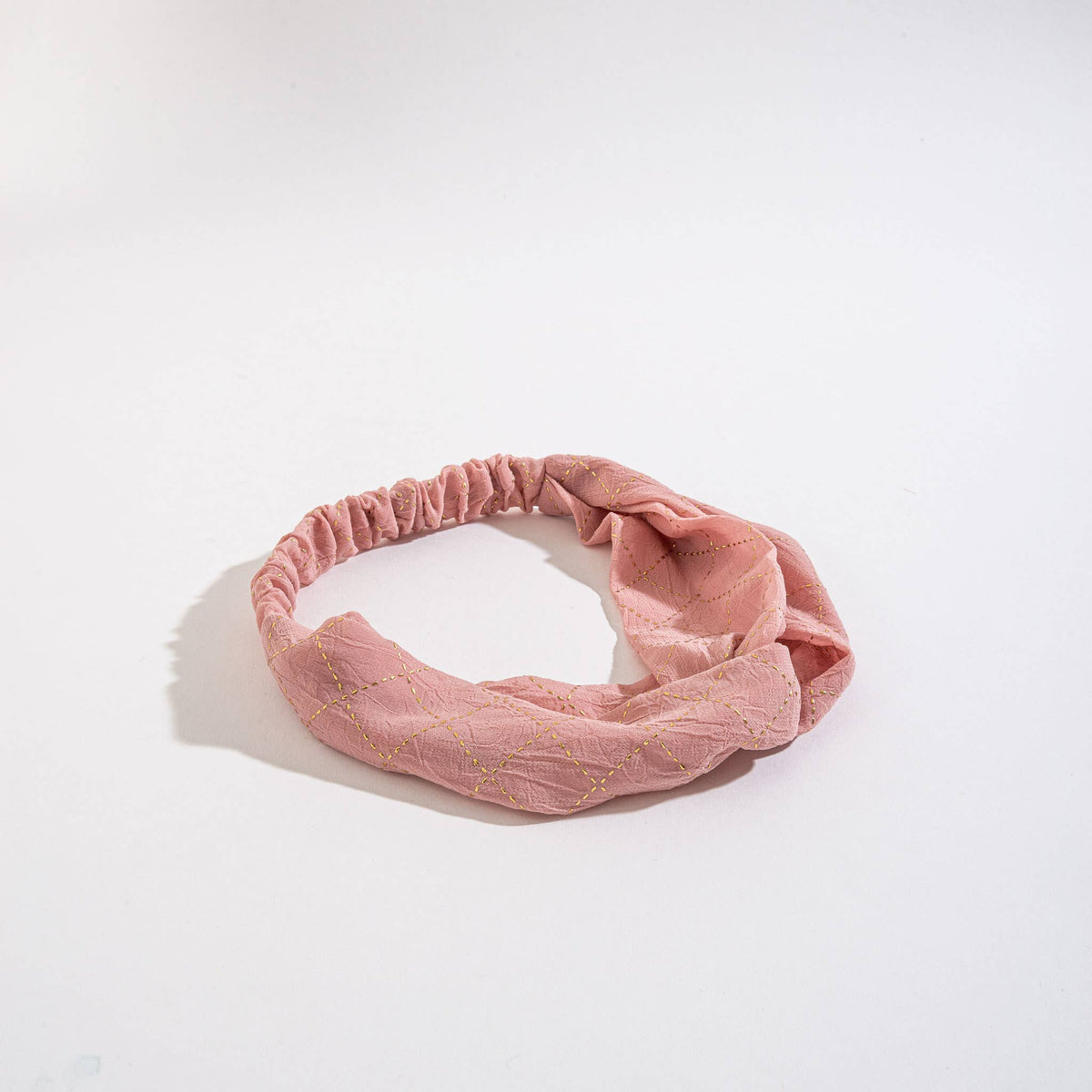 Howard's Peyton Twist Headband featuring a stylish twisted design, perfect for adding a chic touch to any hairstyle.
