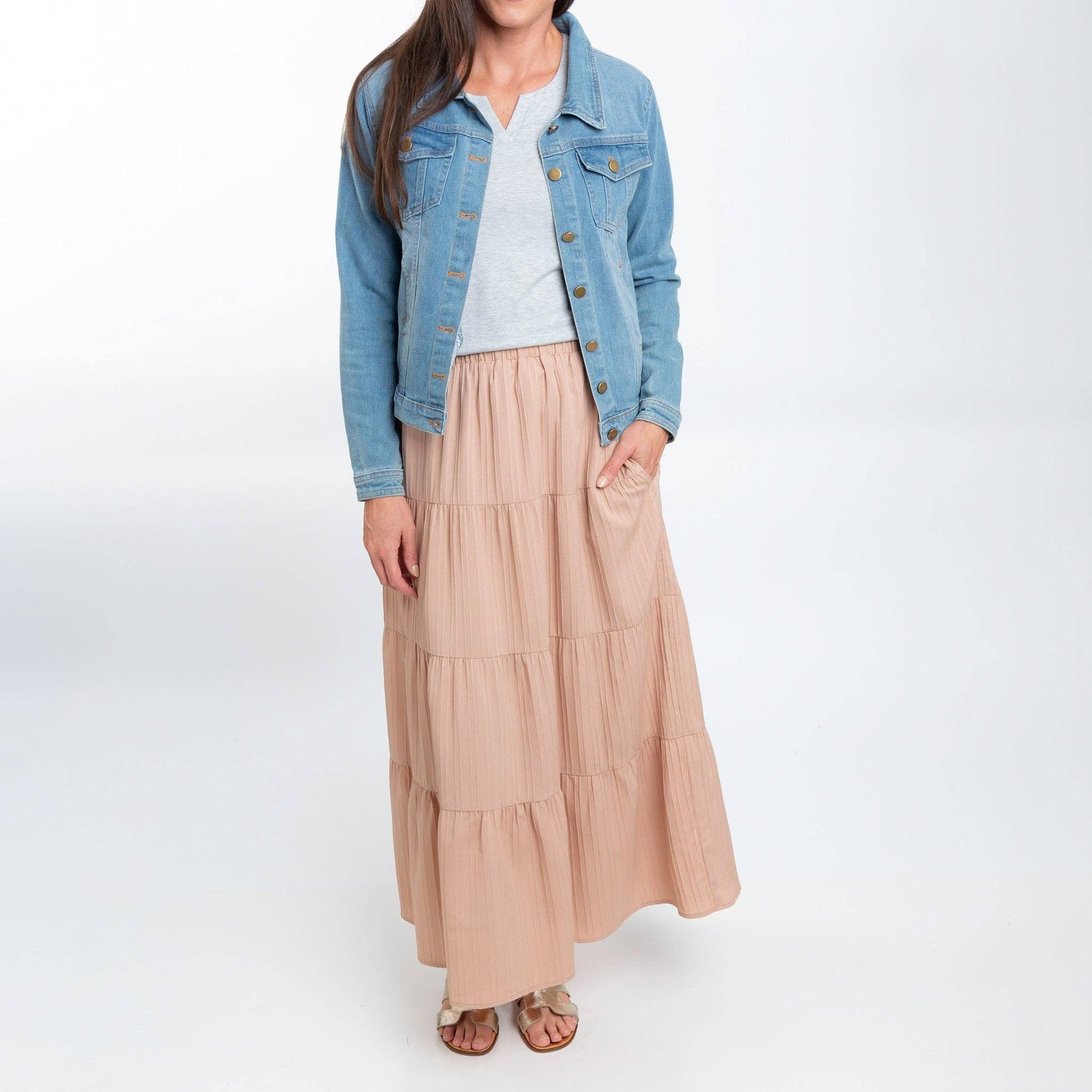 Howard's McKay tiered rosewater maxi skirt with pockets, featuring flowing fabric and a tiered design, displayed on a hanger.